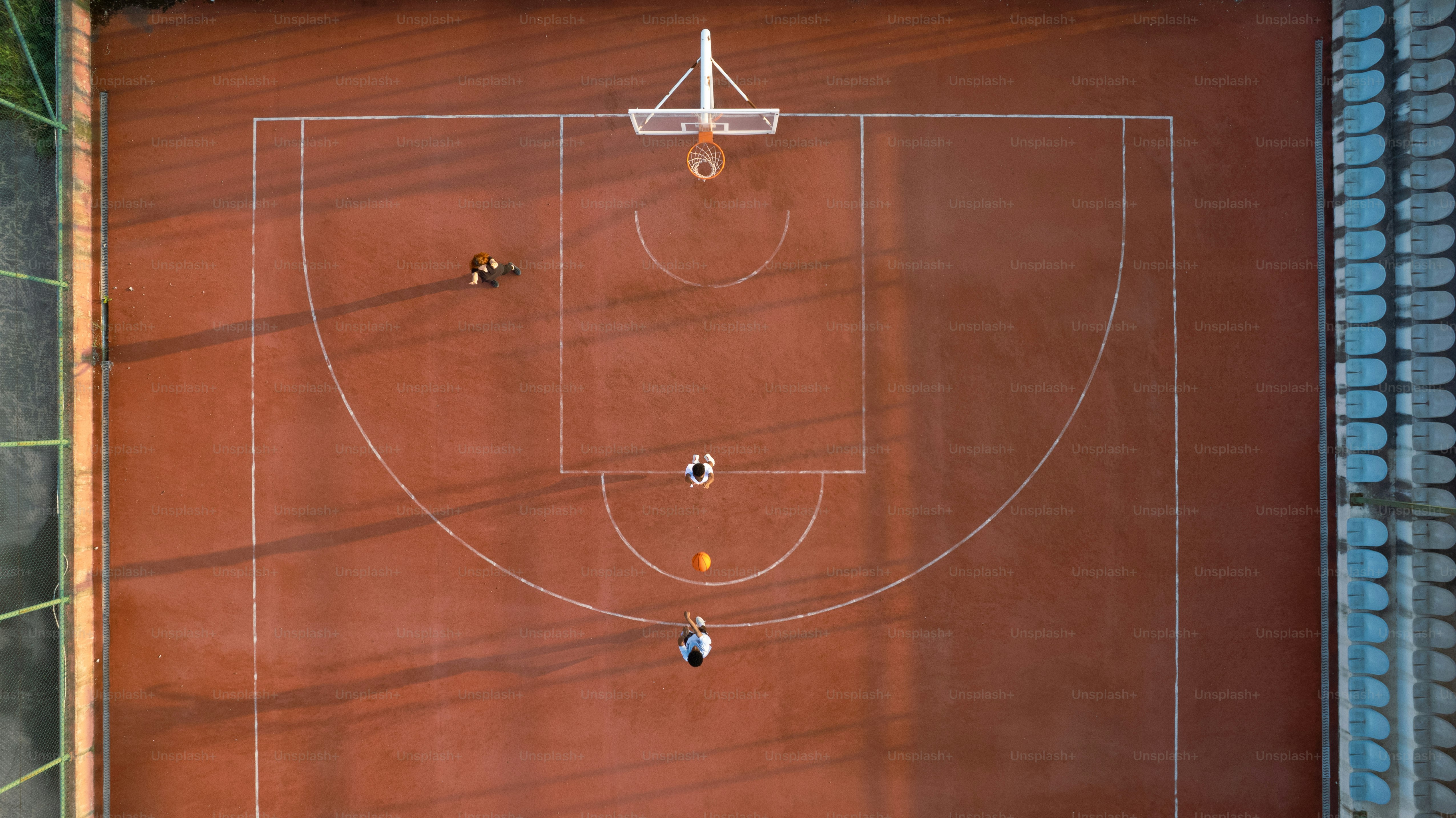 an overhead view of a basketball court with people on it